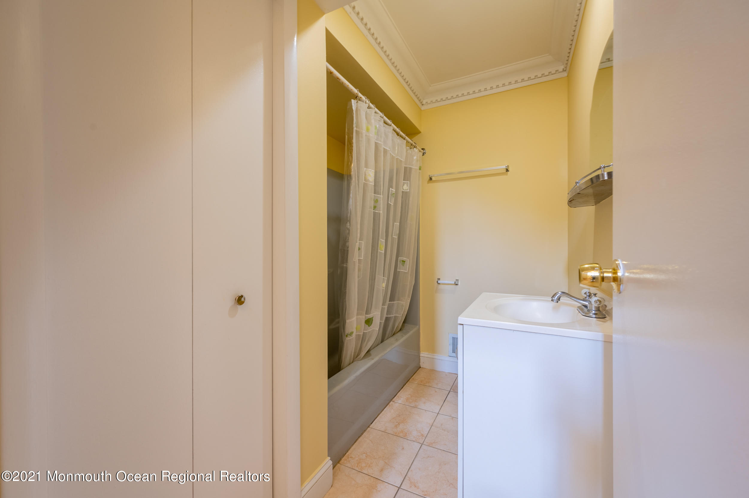 2816 Shafto Road Tinton Falls, NJ 07753 - Photo 18 of 24 a bathroom with a sink a mirror and a shower