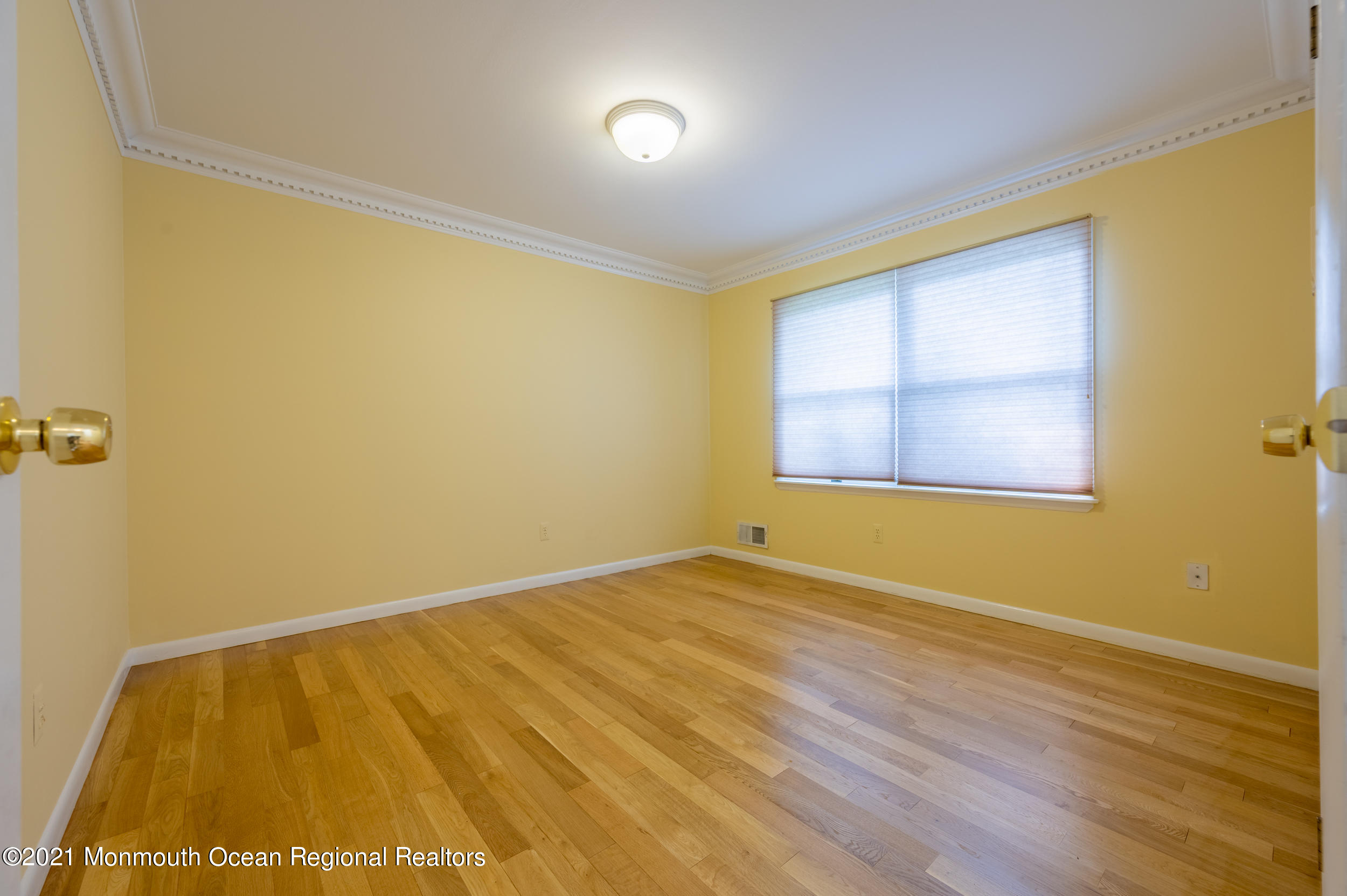 2816 Shafto Road Tinton Falls, NJ 07753 - Photo 19 of 24 a view of an empty room with wooden floor and a window