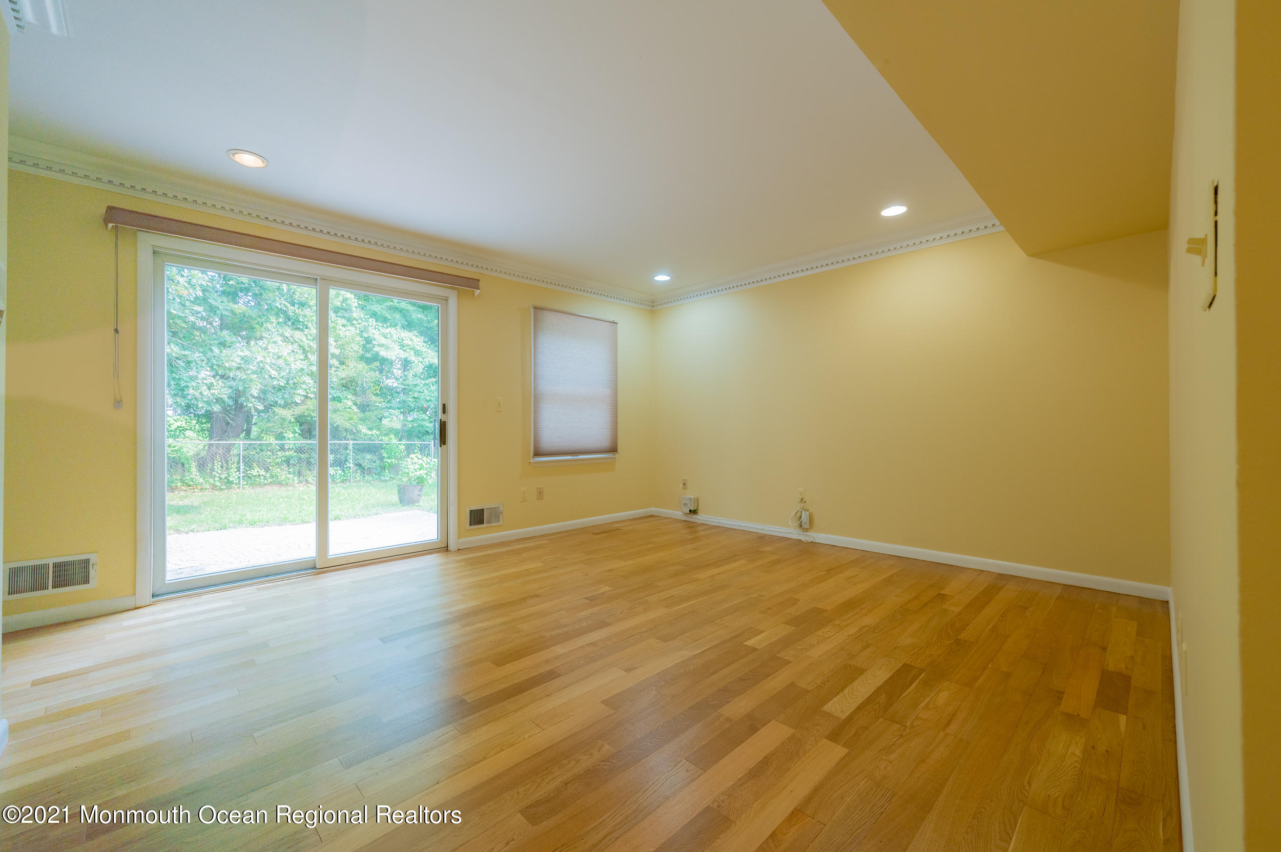2816 Shafto Road Tinton Falls, NJ 07753 - Photo 20 of 24 a view of an empty room with wooden floor and a window