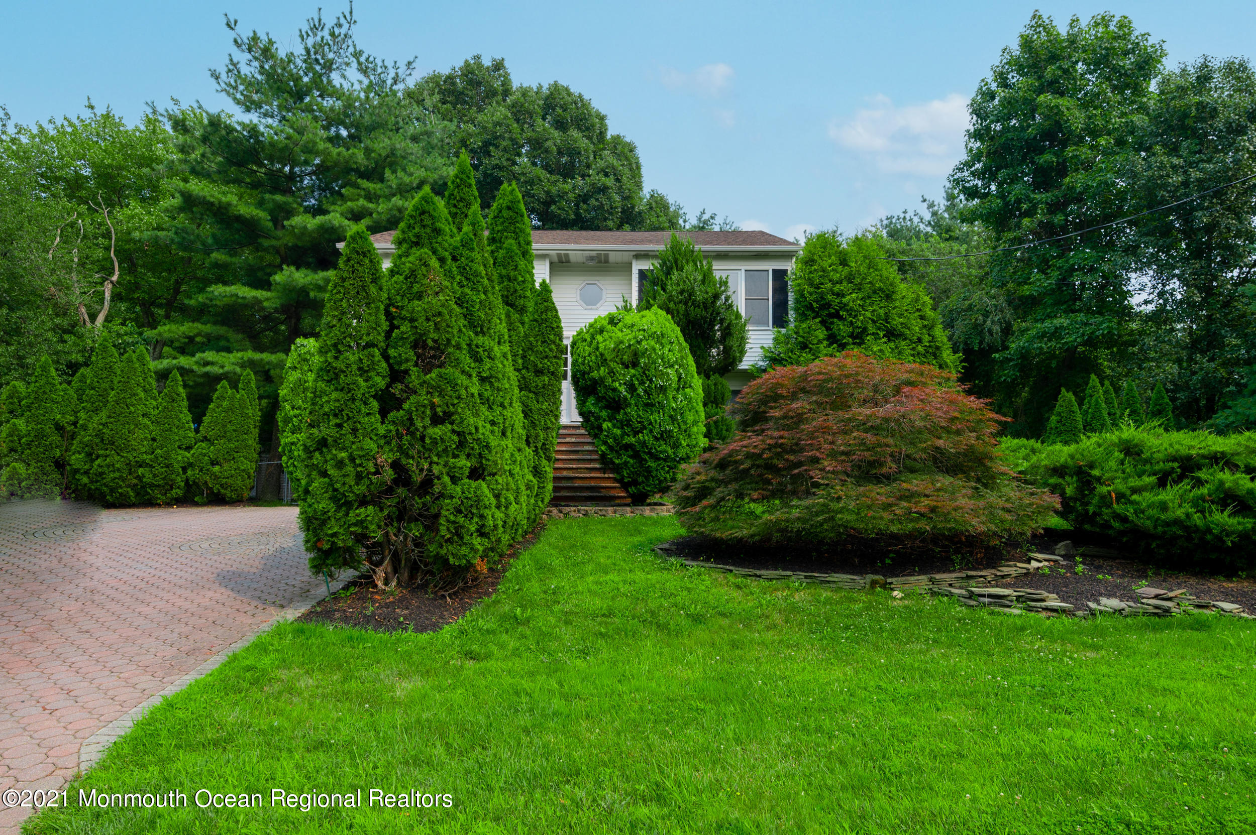 2816 Shafto Road Tinton Falls, NJ 07753 - Photo 3 of 24 a view of a garden with plants and large trees