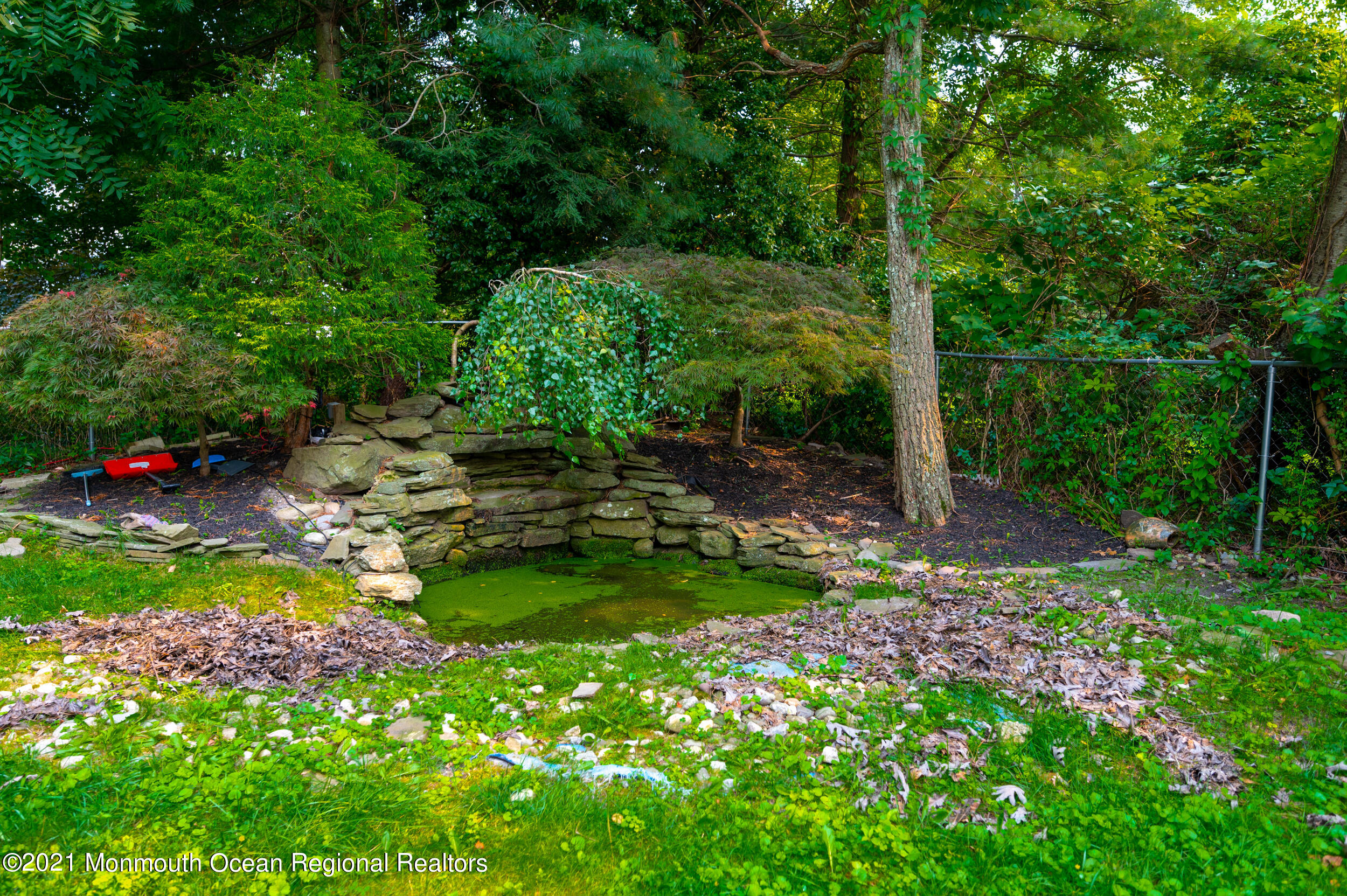2816 Shafto Road Tinton Falls, NJ 07753 - Photo 24 of 24 a backyard of a house with lots of green space and chair