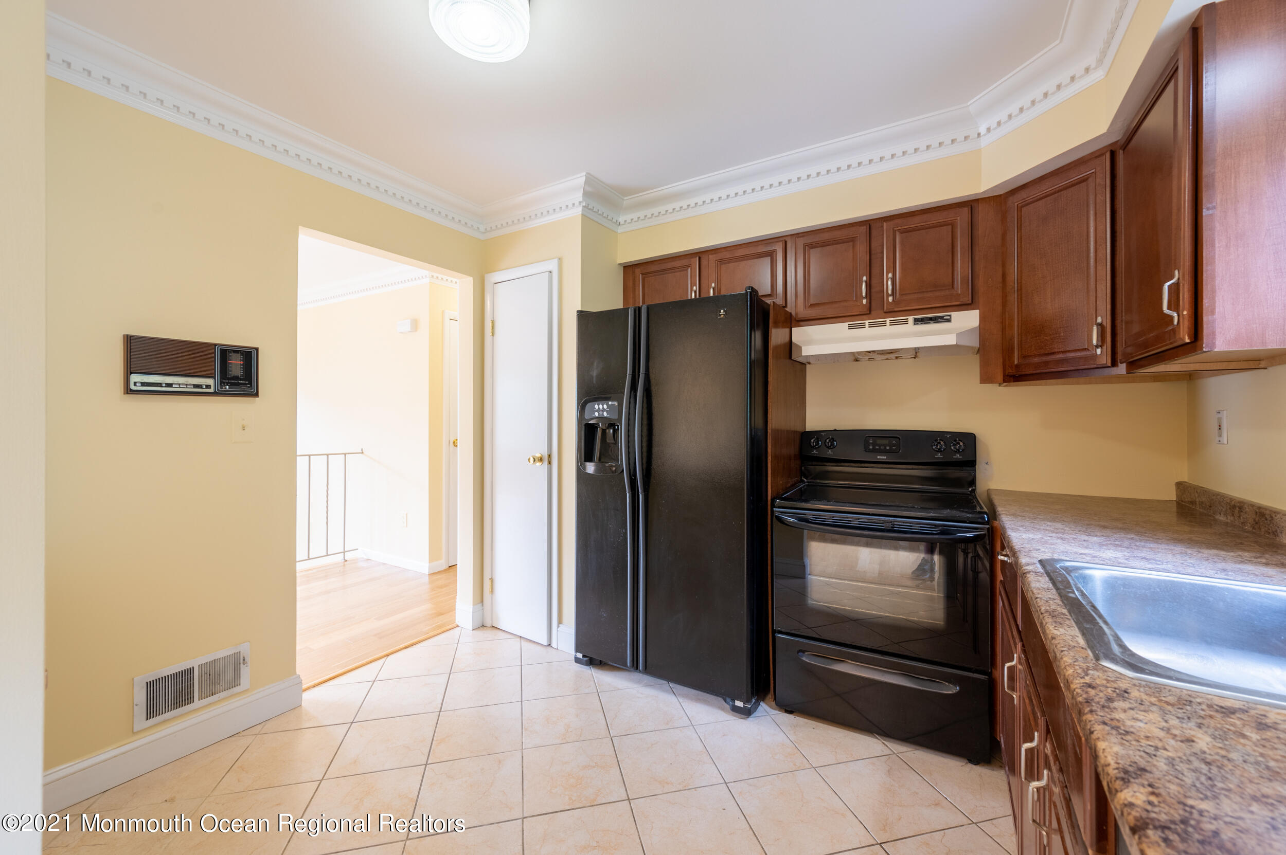 2816 Shafto Road Tinton Falls, NJ 07753 - Photo 8 of 24 a kitchen with granite countertop a refrigerator and a stove top oven