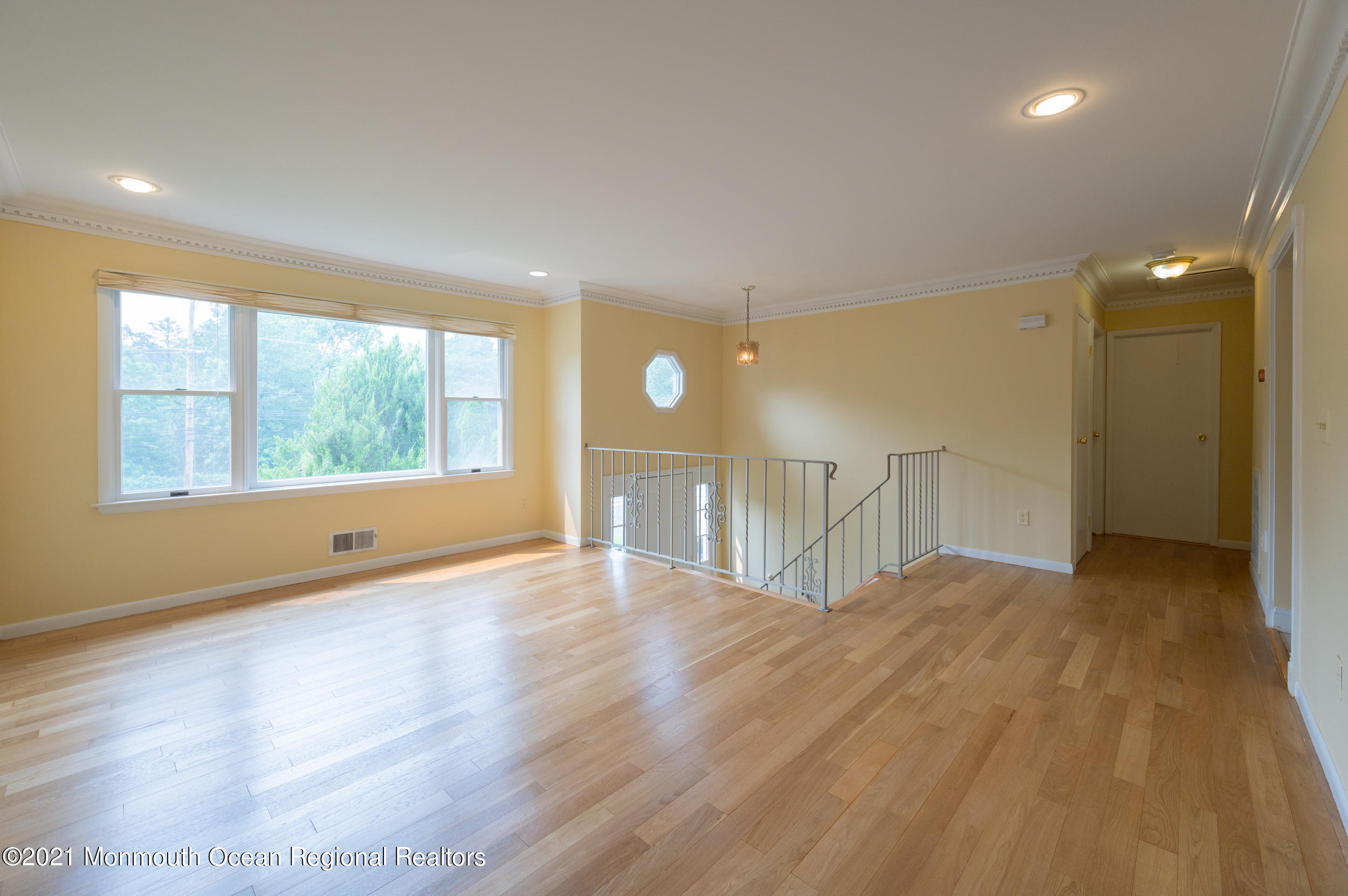 2816 Shafto Road Tinton Falls, NJ 07753 - Photo 9 of 24 a view of an empty room with wooden floor and a window
