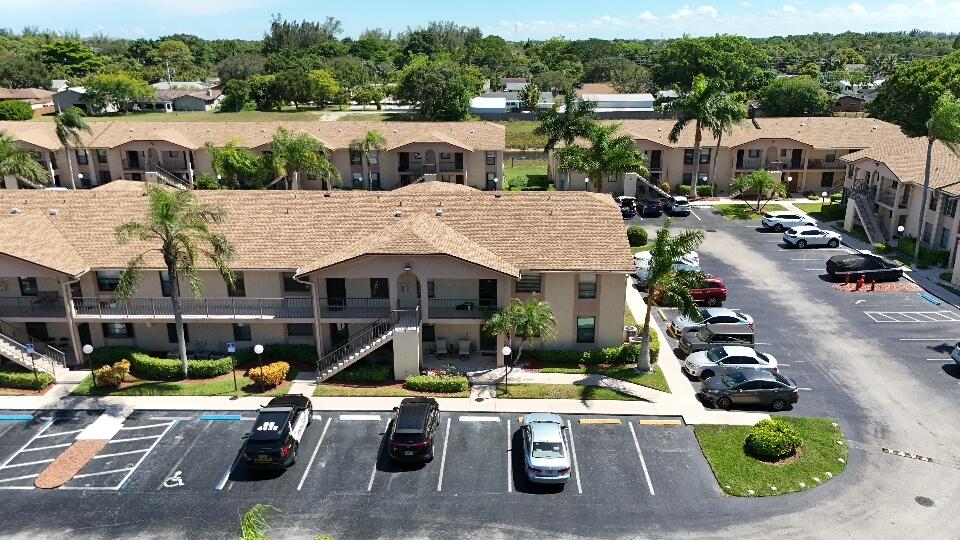 9480 Boca Cove Circle, Unit 416 Boca Raton, FL 33428 - Photo 1 of 15 a view of a patio with couches table and chairs
