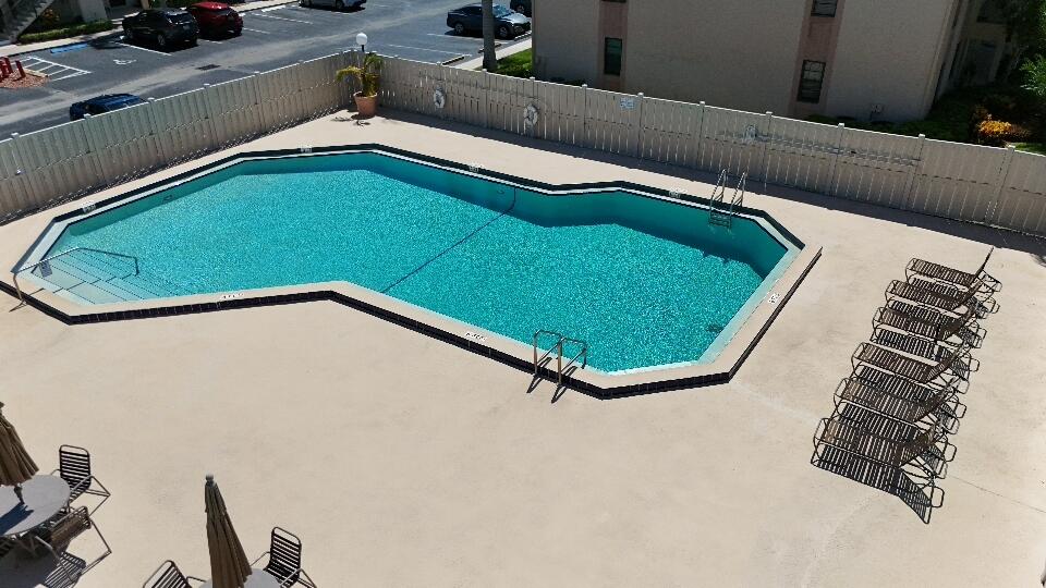 9480 Boca Cove Circle, Unit 416 Boca Raton, FL 33428 - Photo 11 of 15 a view of a living room with a bed and furniture