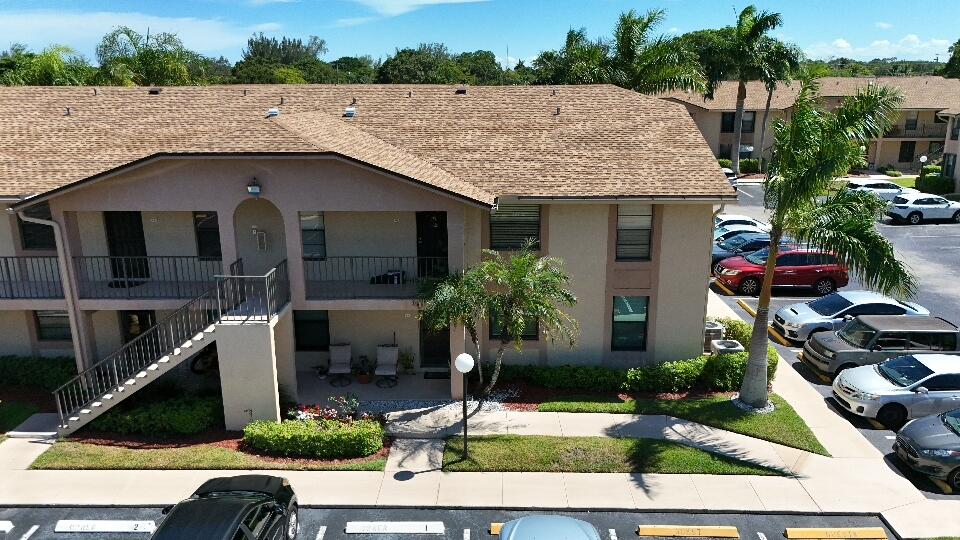 9480 Boca Cove Circle, Unit 416 Boca Raton, FL 33428 - Photo 3 of 15 a front view of a house with garden