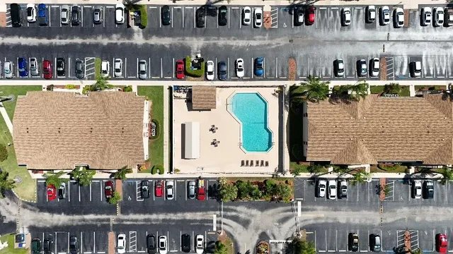 a close view of water kitchen with stainless steel refrigerator and dining table