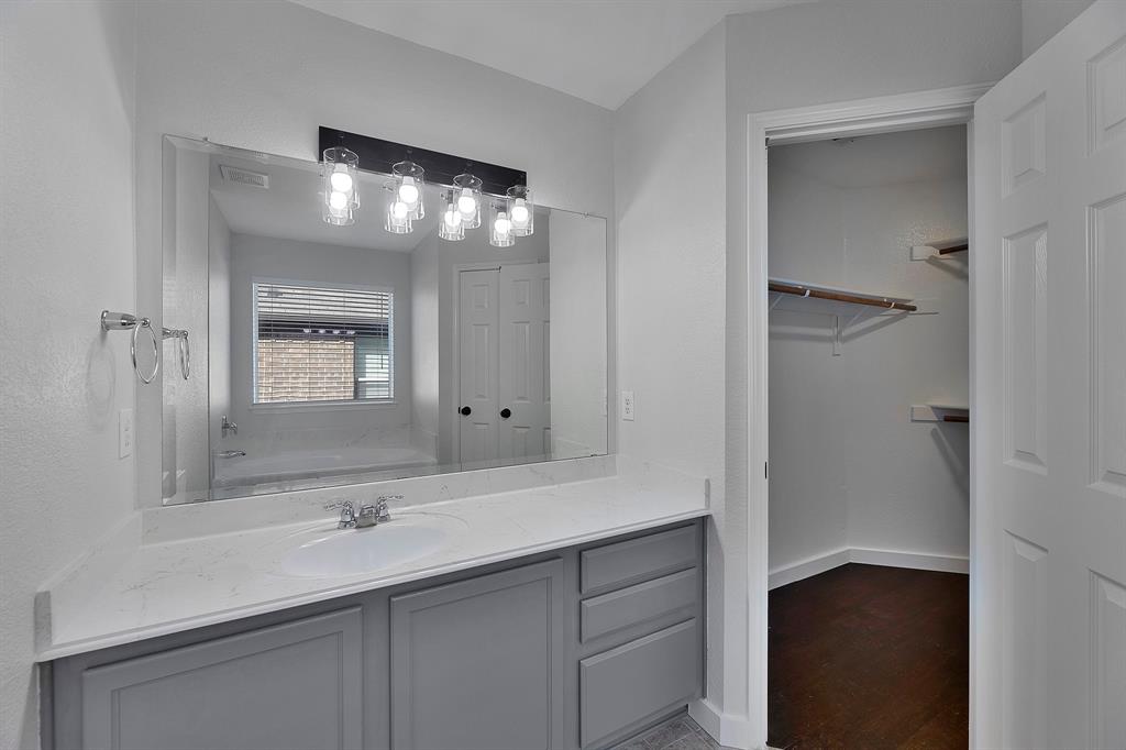605 Clearbrook Street Azle, TX 76020 - Photo 17 of 33 Bathroom vanity featuring a single basin, quartz-finish countertop, and gray shaker-style cabinetry