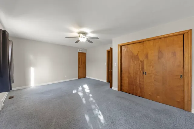 a view of a livingroom with a ceiling fan and window