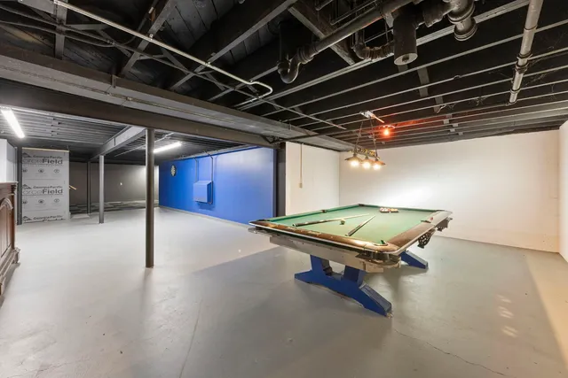 a room with pool table and windows