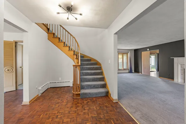 a view of entryway and hall with wooden floor