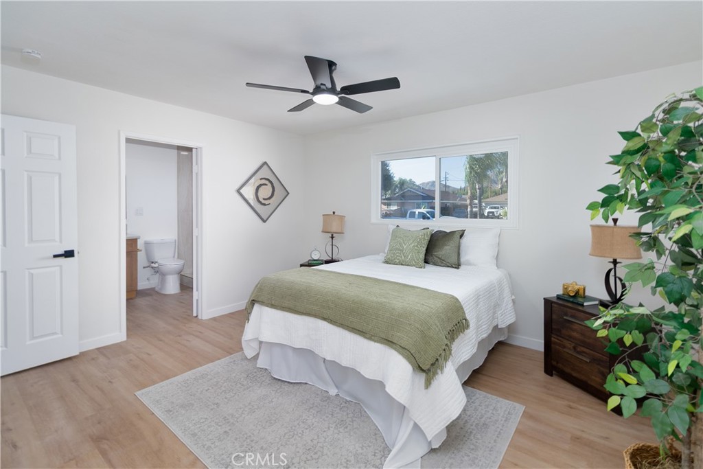 3306 Debbie Lane Riverside, CA 92501 - Photo 22 of 32 a bedroom with a bed and a potted plant