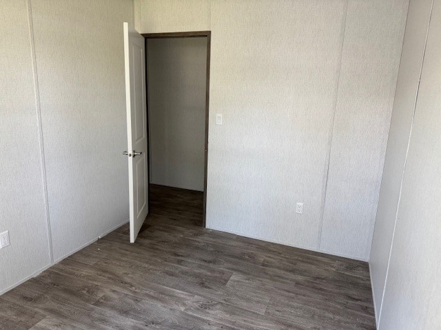 21071 Pinetex Street New Caney, TX 77357 - Photo 12 of 12 a view of an empty room with closet and wooden floor