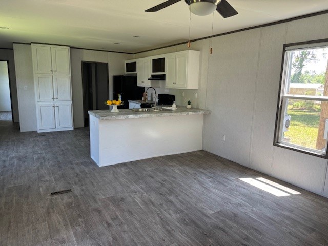 21071 Pinetex Street New Caney, TX 77357 - Photo 2 of 12 a view of kitchen with wooden floor and window