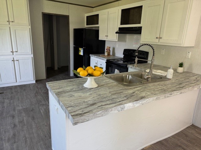21071 Pinetex Street New Caney, TX 77357 - Photo 3 of 12 a kitchen with stainless steel appliances granite countertop a sink stove and microwave