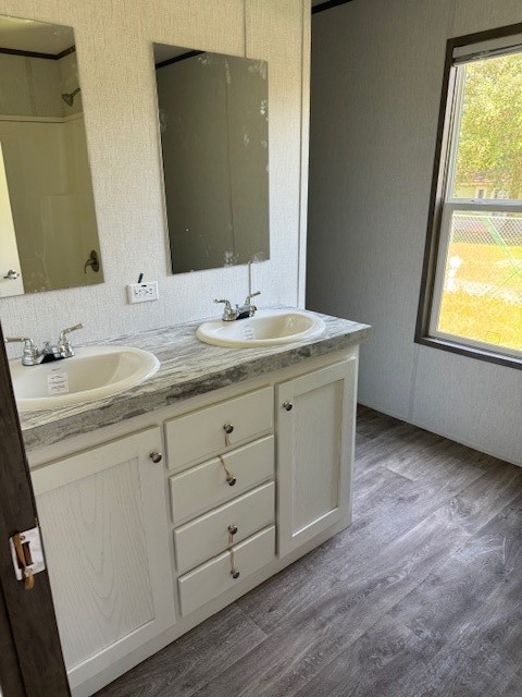 21071 Pinetex Street New Caney, TX 77357 - Photo 8 of 12 a bathroom with a granite countertop sink and a mirror