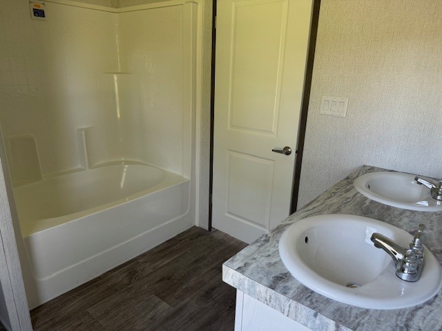 21071 Pinetex Street New Caney, TX 77357 - Photo 9 of 12 a bathroom with a sink and a tub