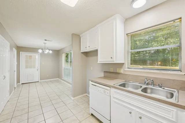 a kitchen with a sink cabinets and window