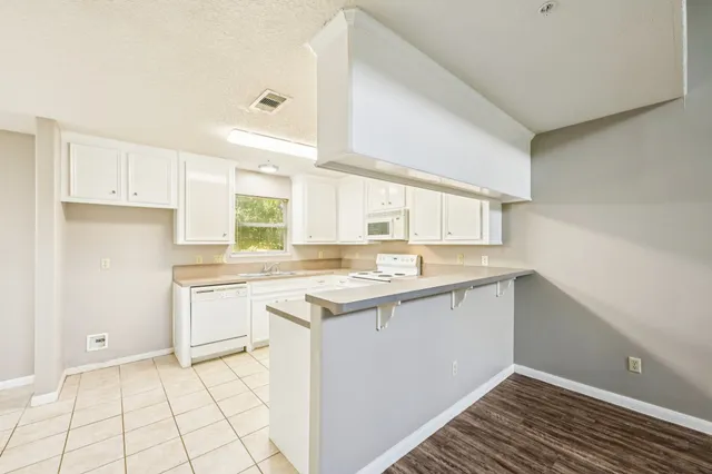 a kitchen with a sink cabinets and window