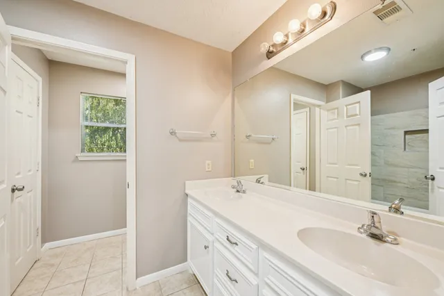a bathroom with a sink a mirror and a shower