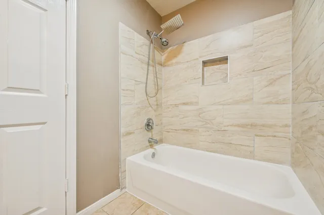 a bathroom with a bathtub and shower