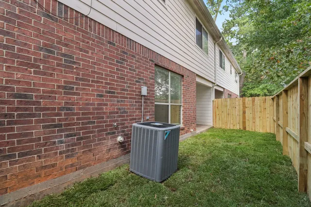 a view of a backyard with plants and wooden fence