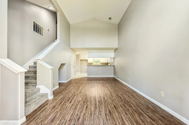 a view of a hallway view with wooden floor and staircase