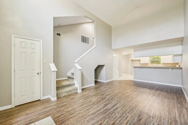 a view of empty room with wooden floor and fireplace
