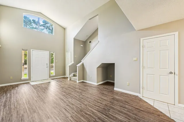 a view of empty room with wooden floor