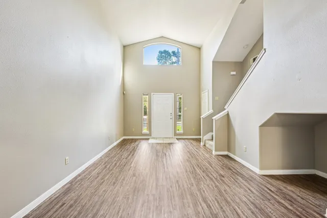 wooden floor in an empty room with a window