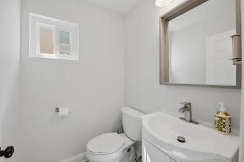 a bathroom with a sink mirror and toilet