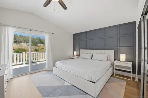 a bedroom with a large bed and a chandelier
