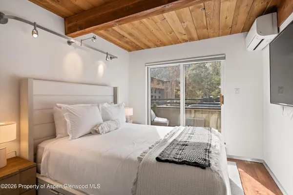 a bedroom with a large bed and a window