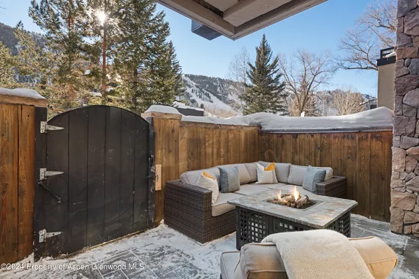 a backyard of a house with table and chairs