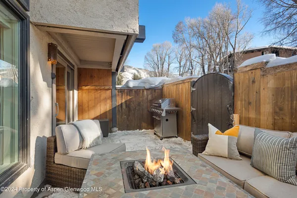 a view of a patio with couches chairs and a fire pit