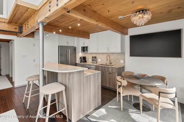 a kitchen with cabinets a sink and chairs
