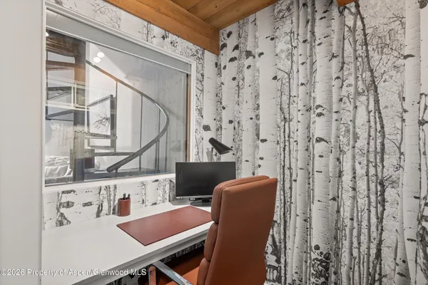 a view of a room with furniture and windows