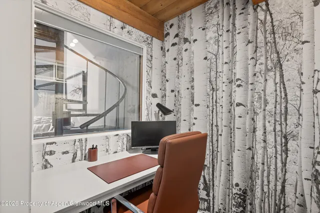 a view of a room with furniture and windows