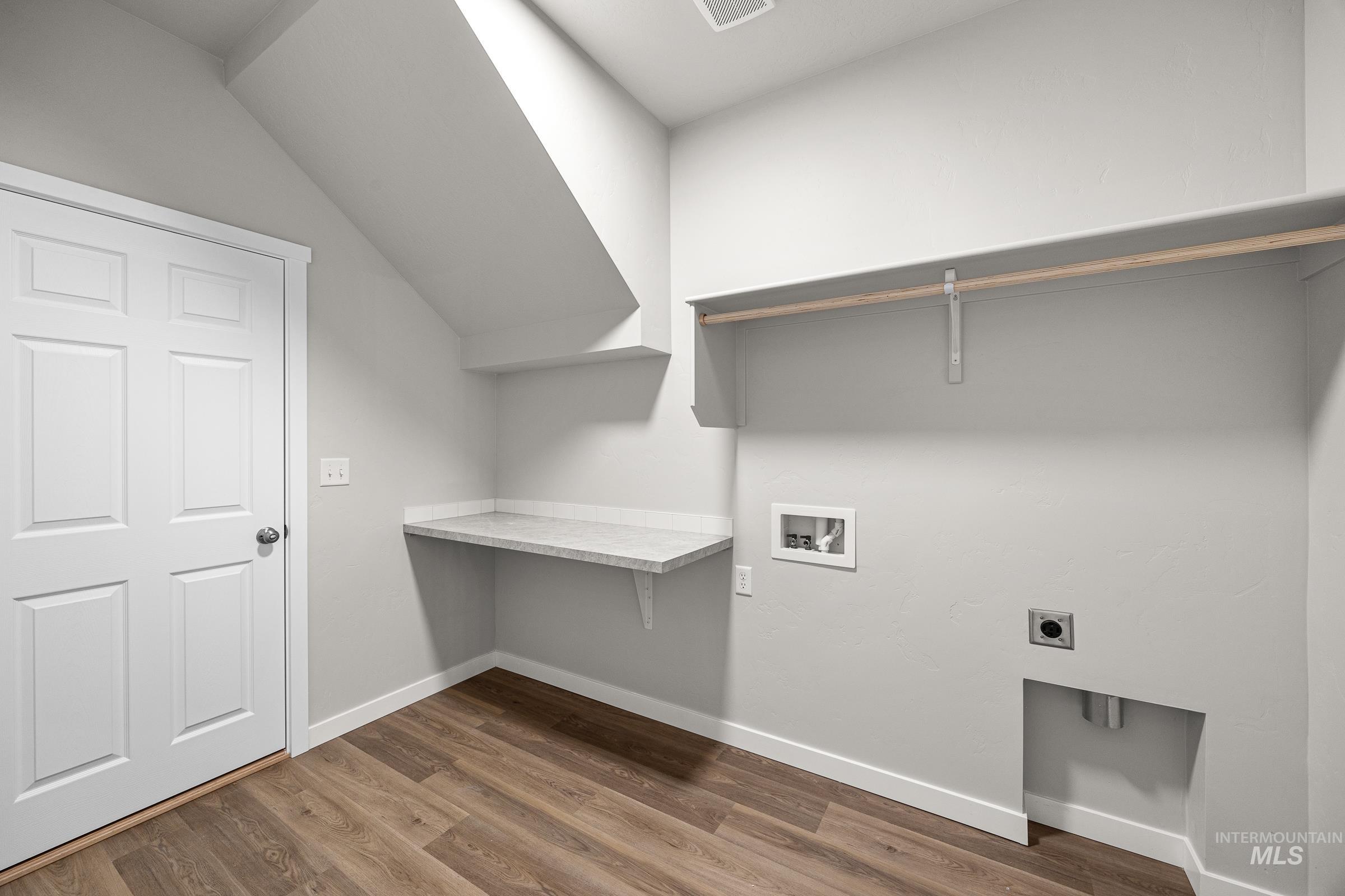 13656 Redway Court Caldwell, ID 83607 - Photo 12 of 21 Dedicated laundry space featuring a side-by-side washer and dryer, built-in shelving, a hanging rod, and a durable countertop workspace