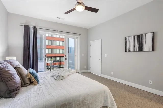 a bed sitting in a bedroom next to a window