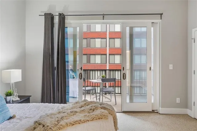 a bedroom with a bed and a lamp next to a window