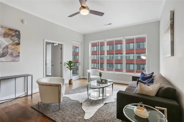 a living room with furniture a lamp and a potted plant