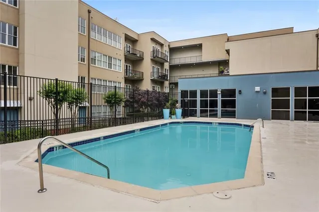 a view of a house with a swimming pool and sitting area