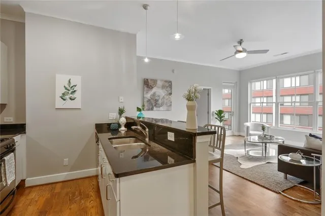 a kitchen with a sink stove and cabinets