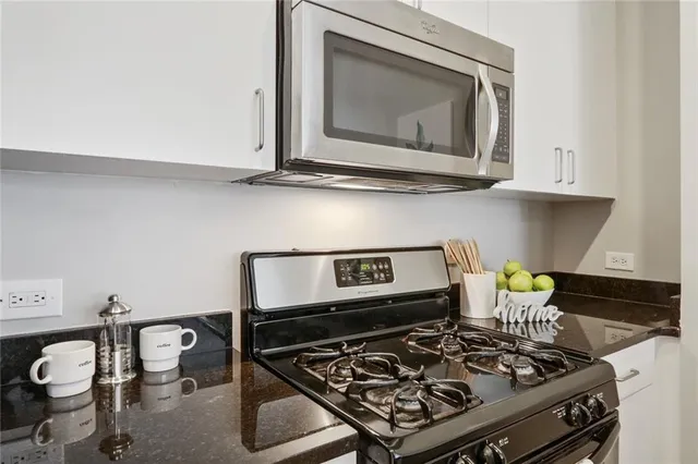 a stove top oven sitting inside of a kitchen