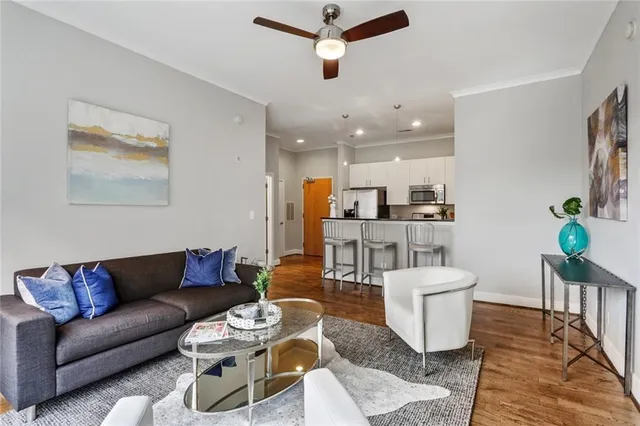 a living room with furniture a rug and a chandelier