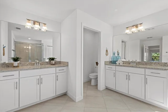 a front view of a house with a garden and plants