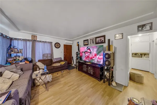 a bed room with furniture and a flat screen tv