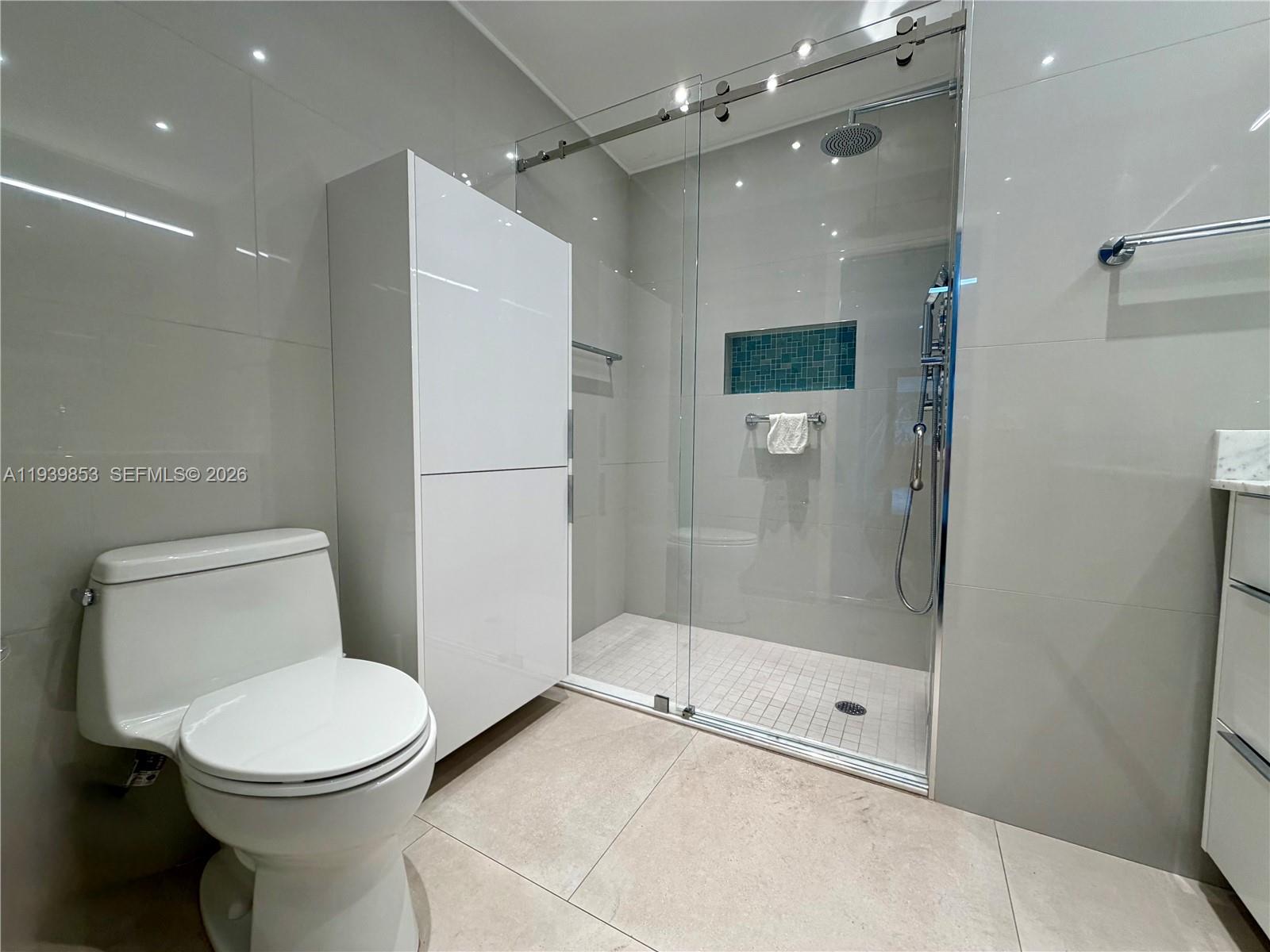 9064 Southwest 6th Street, Unit 9064 Miami, FL 33174 - Photo 12 of 20 a bathroom with a toilet and a shower