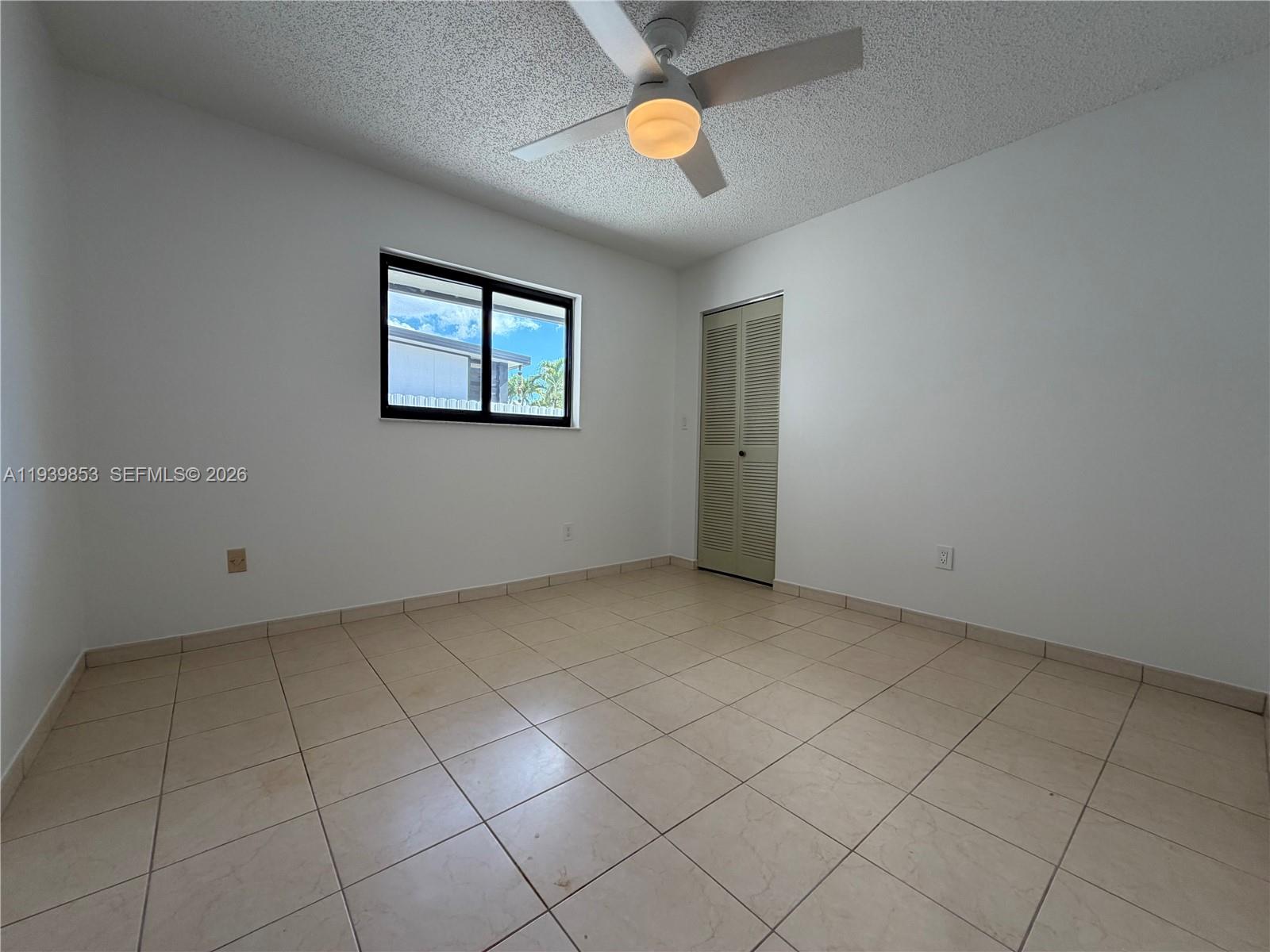 9064 Southwest 6th Street, Unit 9064 Miami, FL 33174 - Photo 14 of 20 an empty room with windows